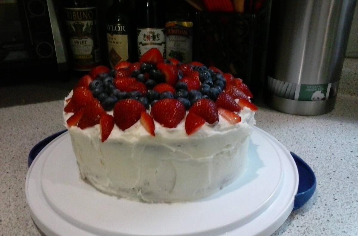 Another doctor bird cake with a strawberry and blueberry topping